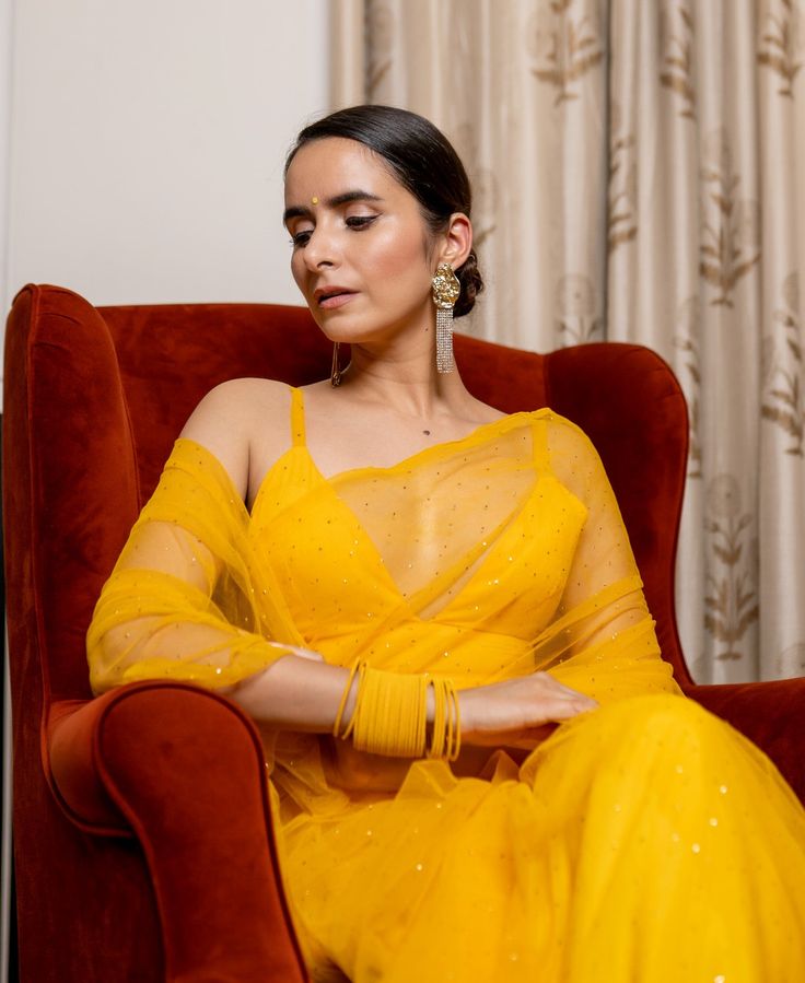 Mukesh Work On Organza SareeFeaturing a yellow pre-stitched saree in organza base. It is paired with a matching strappy v-neck blouse. Delivery time 15 to 20 days V-neck Sheer Dupatta For Diwali, Yellow Fitted Organza Pre-draped Saree, Party Yellow Organza Pre-draped Saree, Yellow Festive V-neck Sets, Festive Yellow V-neck Set, Yellow Blouse Piece With Sheer Dupatta, Party V-neck Georgette Saree, Yellow Anarkali Style Organza Pre-draped Saree, Sheer Dupatta Blouse For Diwali Puja