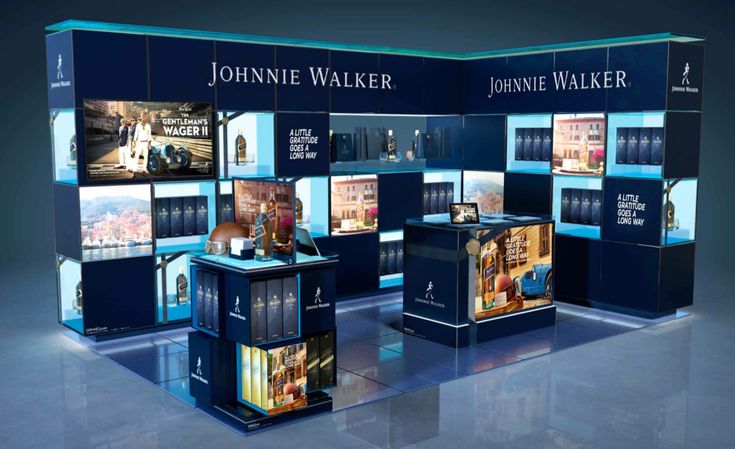 an exhibit booth with blue walls and pictures on it