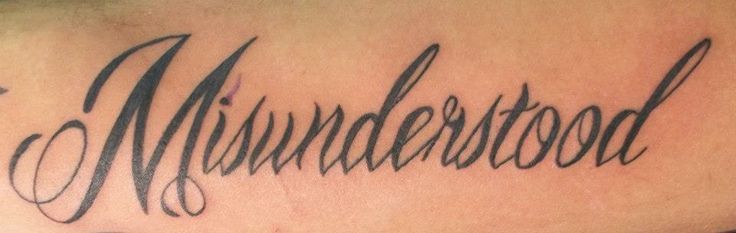 a tattoo with the word murdered written in cursive writing on it's back