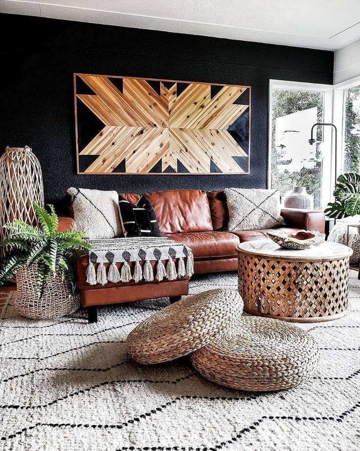 a living room filled with lots of furniture next to a large painting on the wall