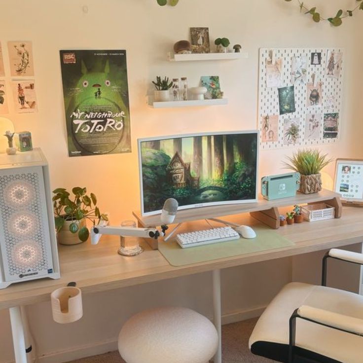 a desk with a computer monitor, keyboard and mouse on it in front of a plant