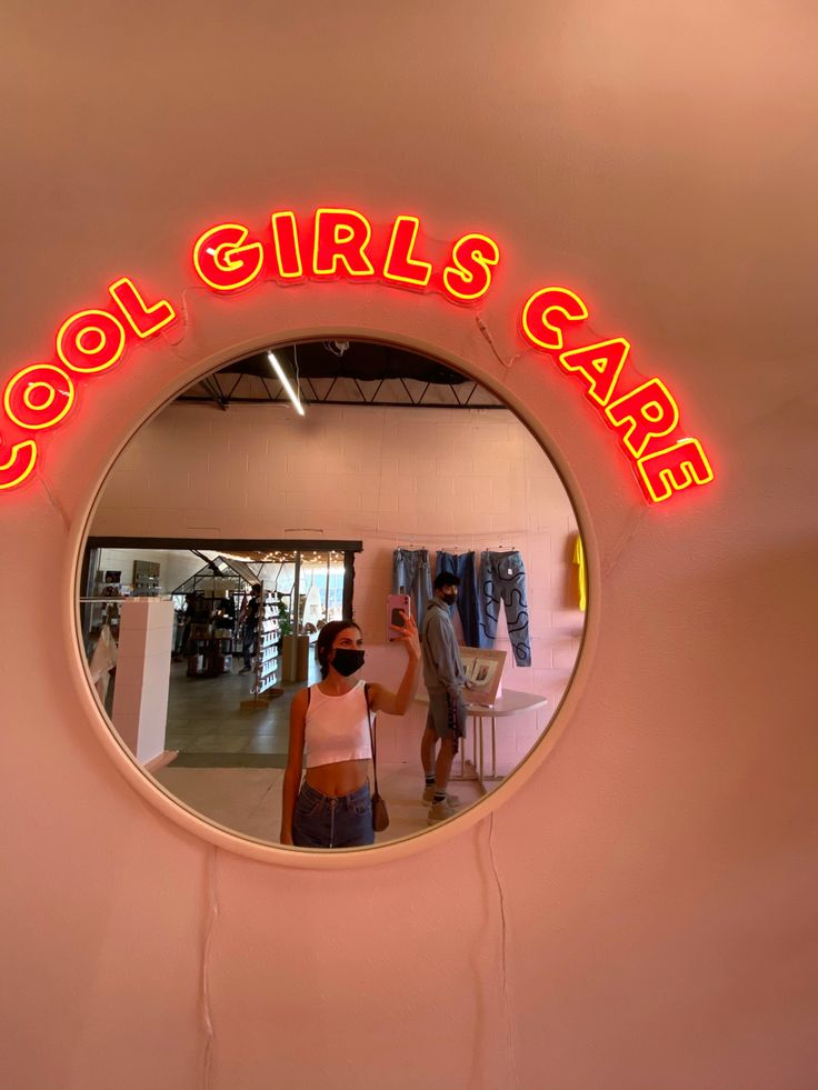 a mirror that says cool girls care in front of a woman's clothing store