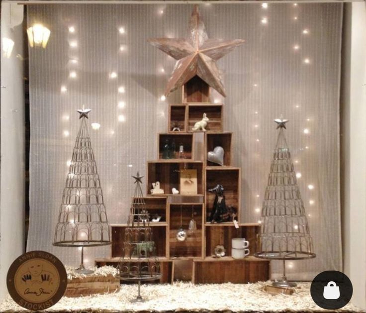 a christmas tree made out of wooden crates with lights on the top and below it