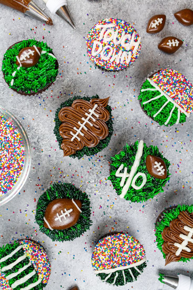 cupcakes decorated to look like sports balls and footballs are on the table