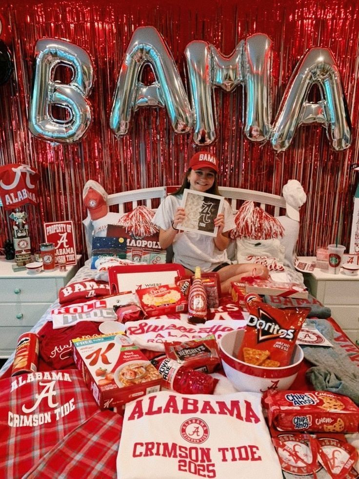 a bed topped with lots of food next to balloons in the shape of letters and numbers