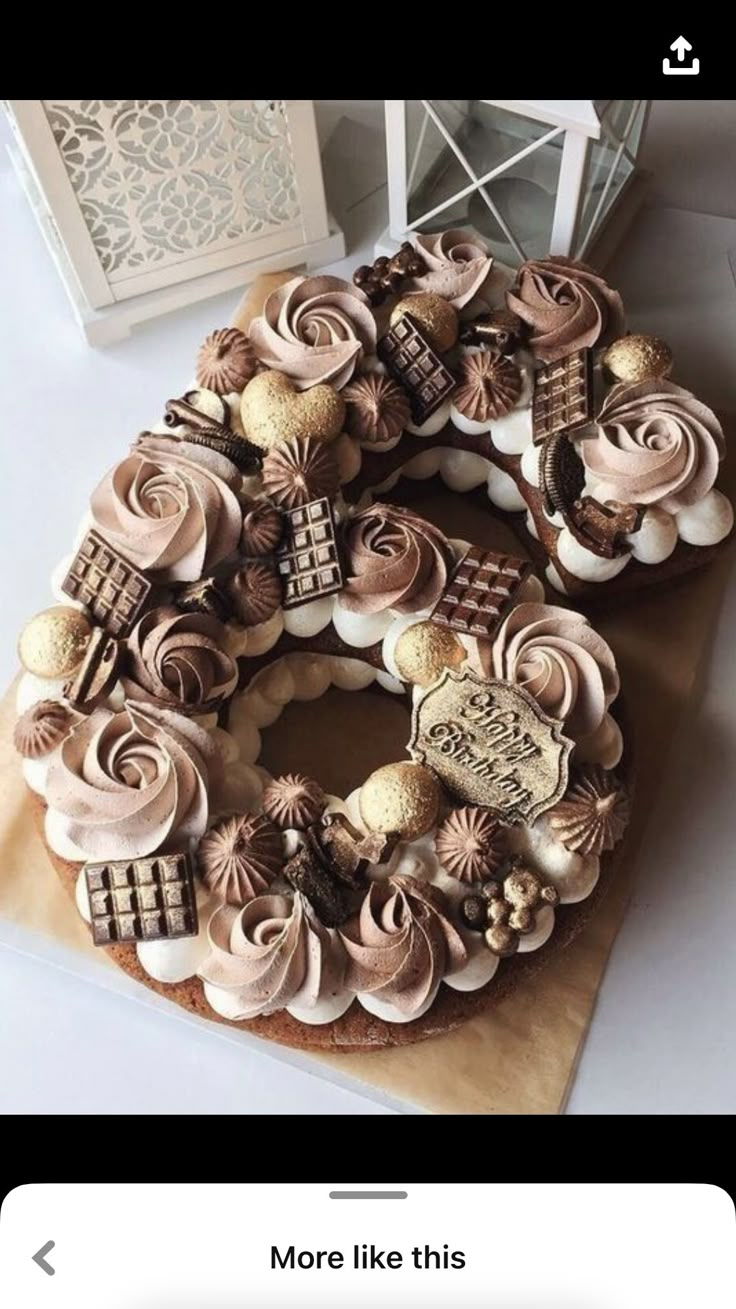 a cake decorated with chocolate and white frosting on top of a wooden cutting board