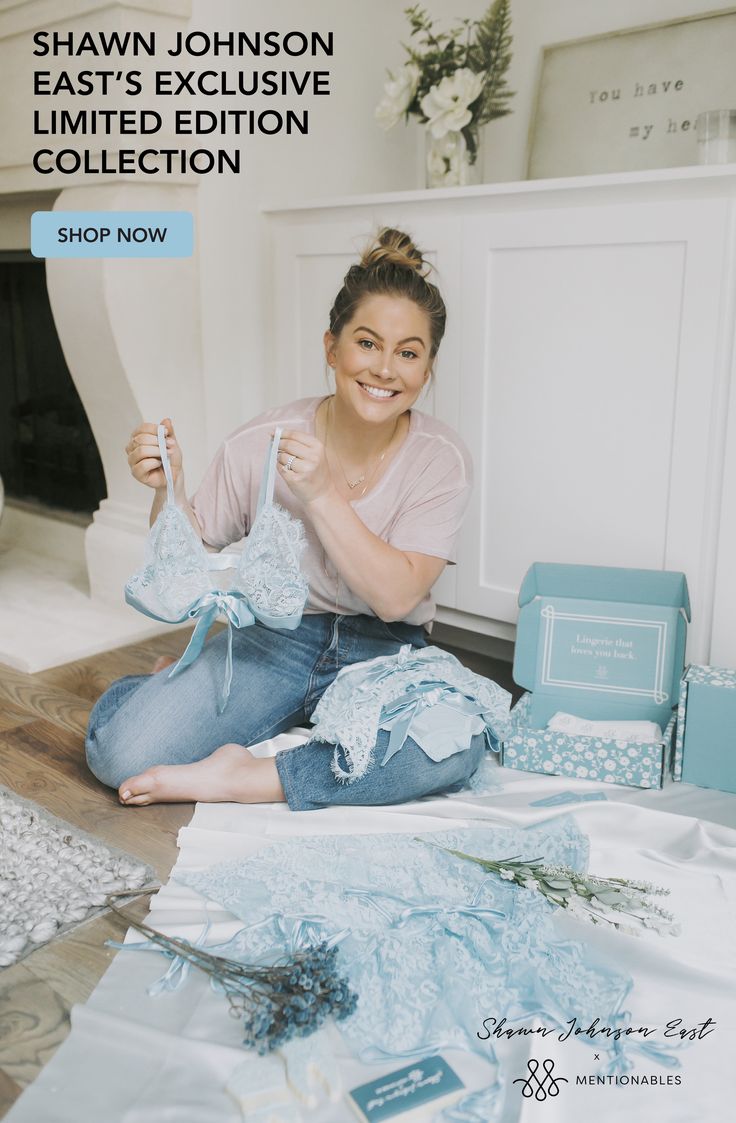 a woman is sitting on the floor with her clothes in front of her, and she has