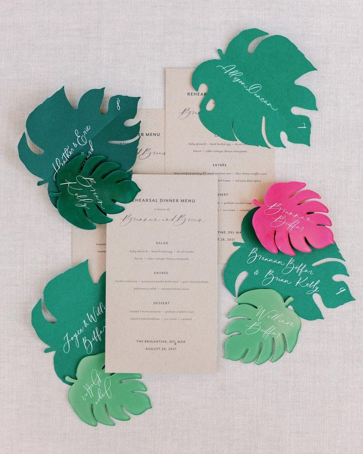 the wedding stationery was done in green, pink and white paper with tropical leaves