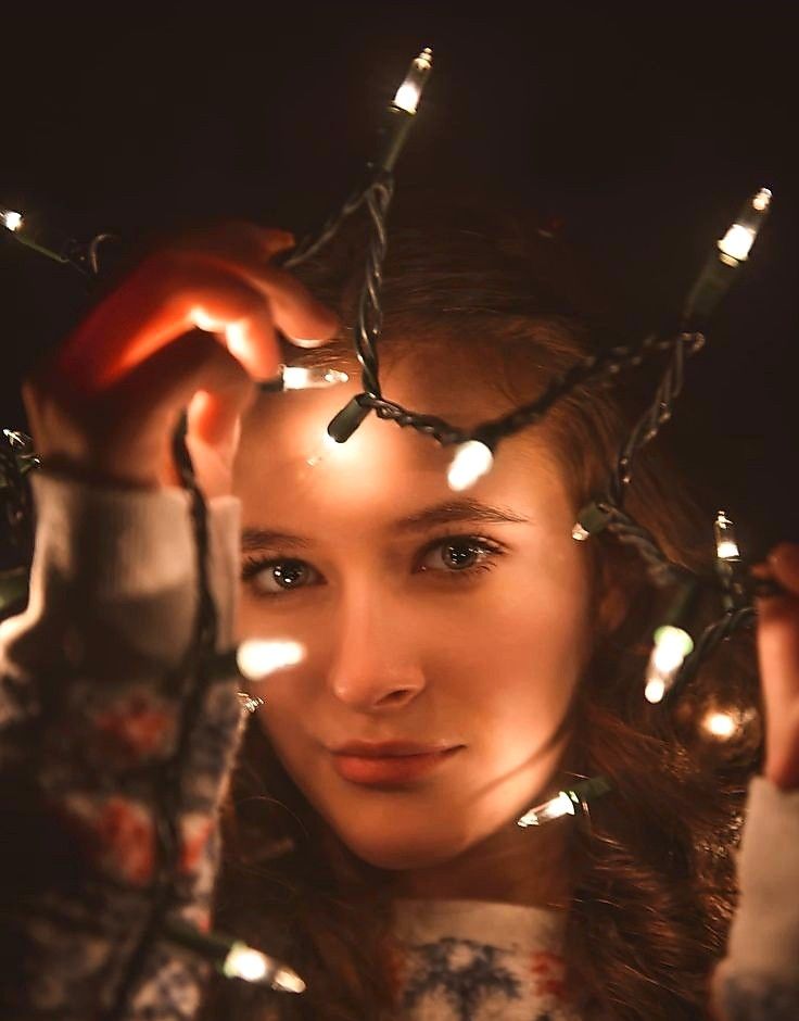 a woman with christmas lights around her head