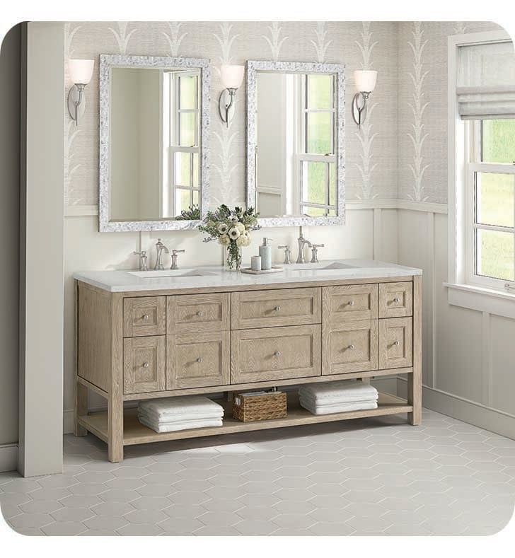 a bathroom vanity with two mirrors above it