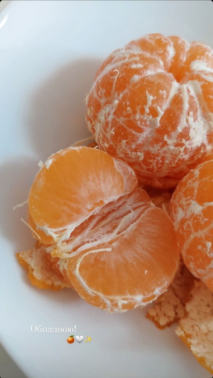 peeled oranges and crackers on a white plate