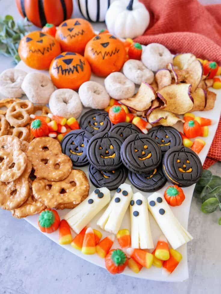 a platter filled with cookies, pretzels, and candy cornucops