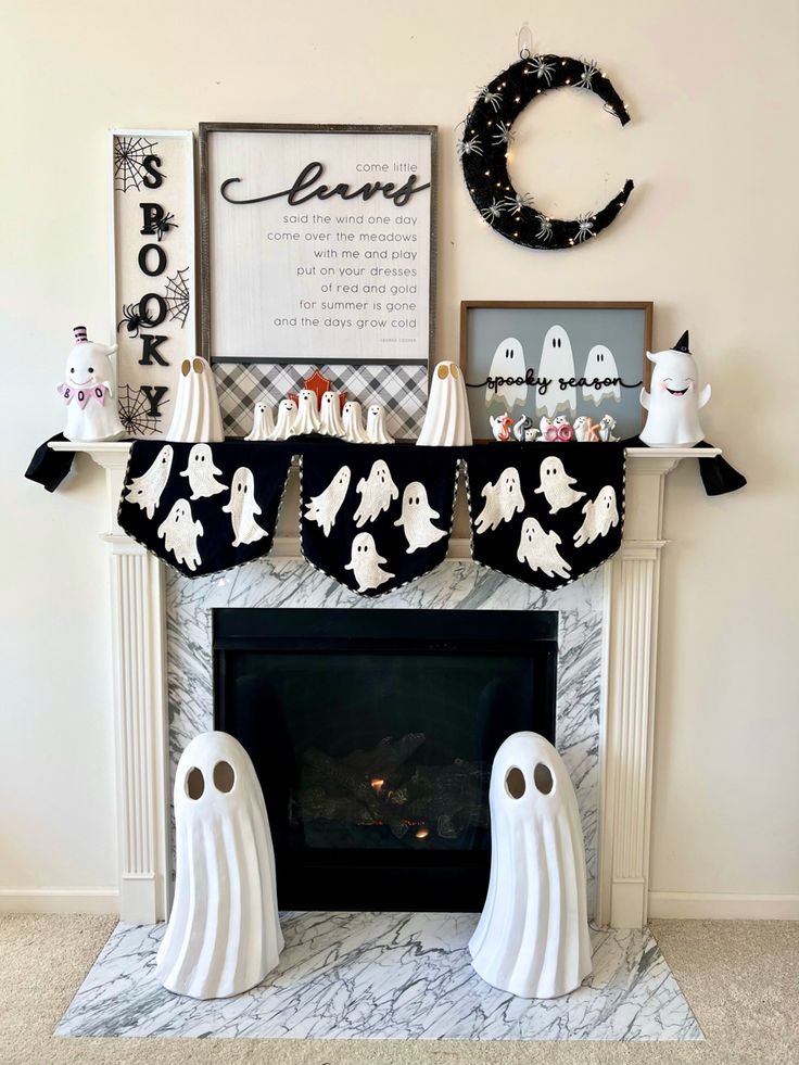 a fireplace decorated for halloween with ghost stockings