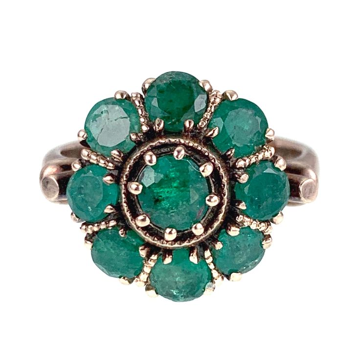 Emeralds have long been believed to confer riches, power and eloquence if worn as talismans. They were thought to strengthen ones memory and help aid in longevity, even providing immortality! The daisy ring became popular during the Victorian Era, and were often given as betrothal rings. Although diamonds were popular, any stone could be given as an engagement promise. This bright green, spirited beauty has nine glittering emeralds set in 12 karat rose gold with leaf-like shoulders. A festive ba Emerald Gem, Buckle Ring, Daisy Ring, The Victorian Era, Gorgeous Jewelry, Bright Green, Victorian Era, Rings Statement, Ring Verlobung