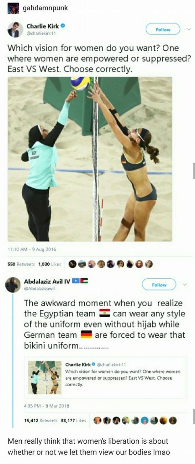 two women in bathing suits playing volleyball on the beach with one woman reaching up to hit the ball