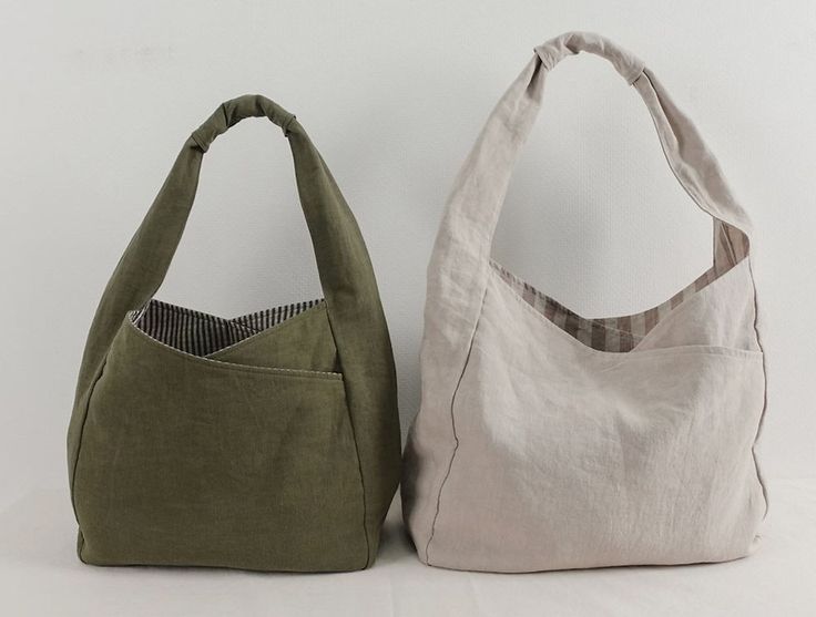 two bags sitting next to each other on a white surface