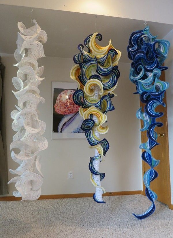 two tall glass sculptures sitting on top of a carpeted floor