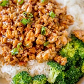 a plate with rice, broccoli and some kind of meat on top of it