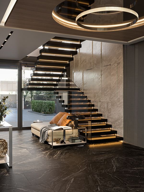 a living room filled with furniture next to a stair case