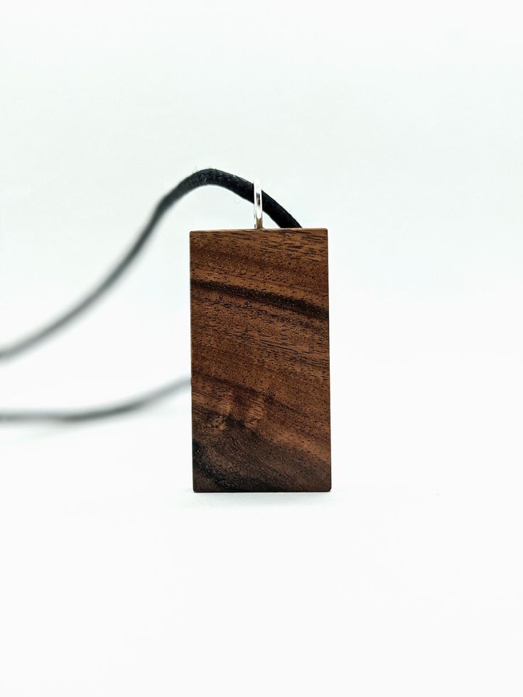 Exotic Wood Necklace. This pendant is made out of Santos Rosewood, a wood commonly found in Tropical south America (Brazil & Bolivia). This wood an amazing grain pattern and a simple design that would make a wonderfull gift for you or a friend! Waxed cotton cord - 65cm - adjustable Wooden Pendant Necklace For Gift, Brown Wood Necklace As Gift, Brown Wooden Necklace For Gifts, Brown Wooden Necklace Gift, Brown Wooden Necklace For Gift, Brown Wooden Necklace Perfect For Gifts, Handmade Ebony Necklaces For Gifts, Handmade Ebony Necklace For Gift, Natural Wood Pendant Necklace