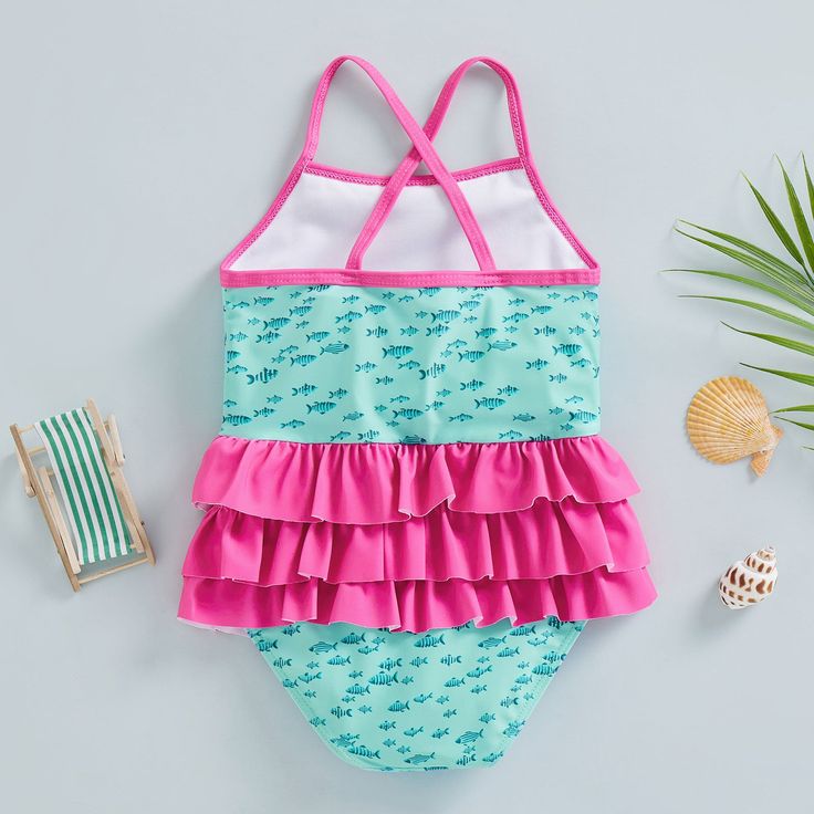 The perfect addition to your little one's summer wardrobe! Made from soft and stretchy fabric, this swimsuit is designed to keep your baby comfortable and stylish during their water adventures. The cute and colorful design with adorable ruffles will make your baby stand out on the beach or by the pool. Playful Ruffled Swimwear For Summer, Playful Green Swimwear With Uv Protection, Cute Swimwear With Uv Protection For Vacation, Cute Ruffled Swimwear For Vacation, Summer Swimwear With Upf 50+ For Playtime, Cute Swimwear With Upf 50+ For Beach, Upf 50+ Swimwear For Beach Season Playtime, Upf 50+ Swimwear For Summer Playtime, Cute Upf 50+ Swimwear For Beach