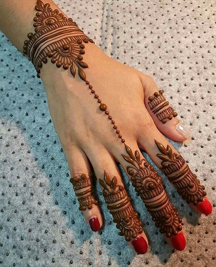 henna tattoo on hand with red nail polish