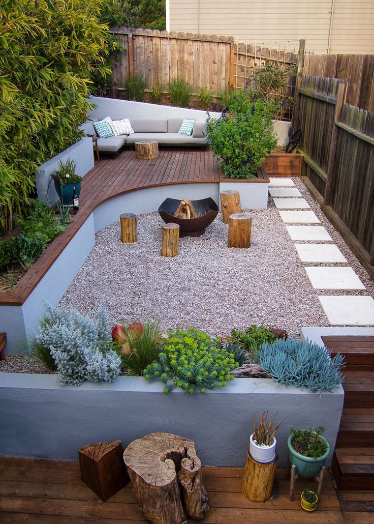 an outdoor garden with gravel, rocks and succulents