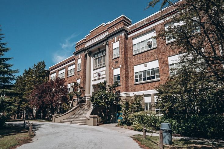 an apartment building with stairs leading up to it