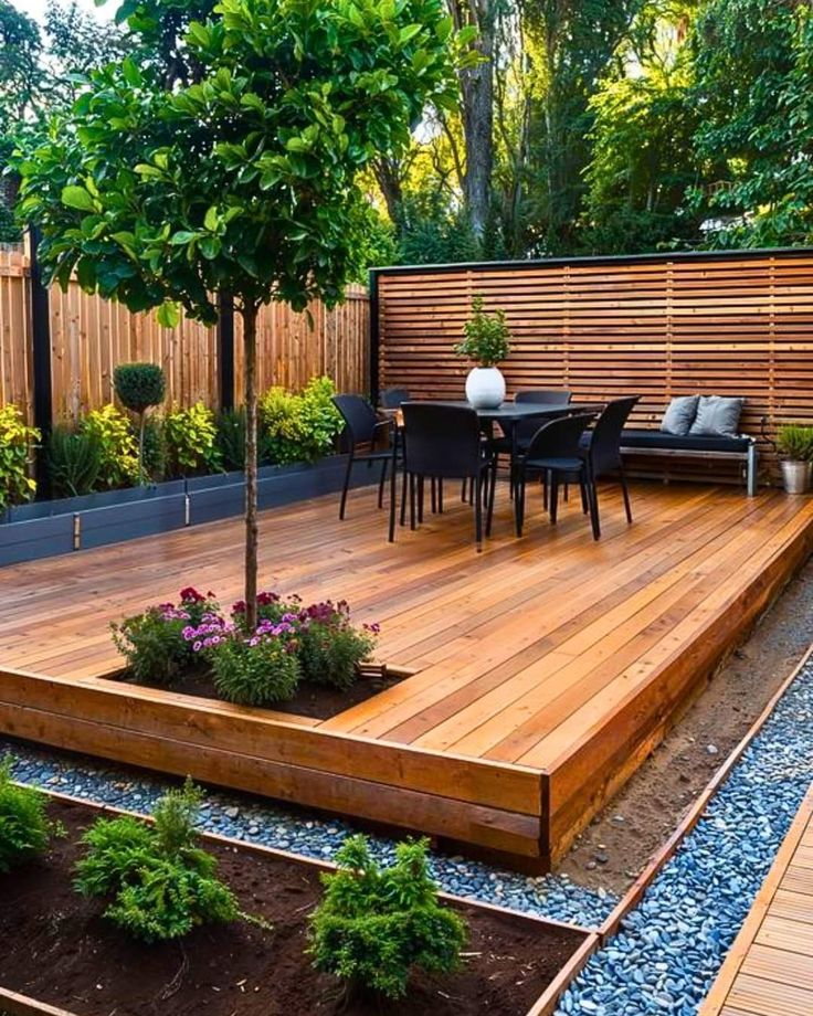 a wooden deck surrounded by plants and trees