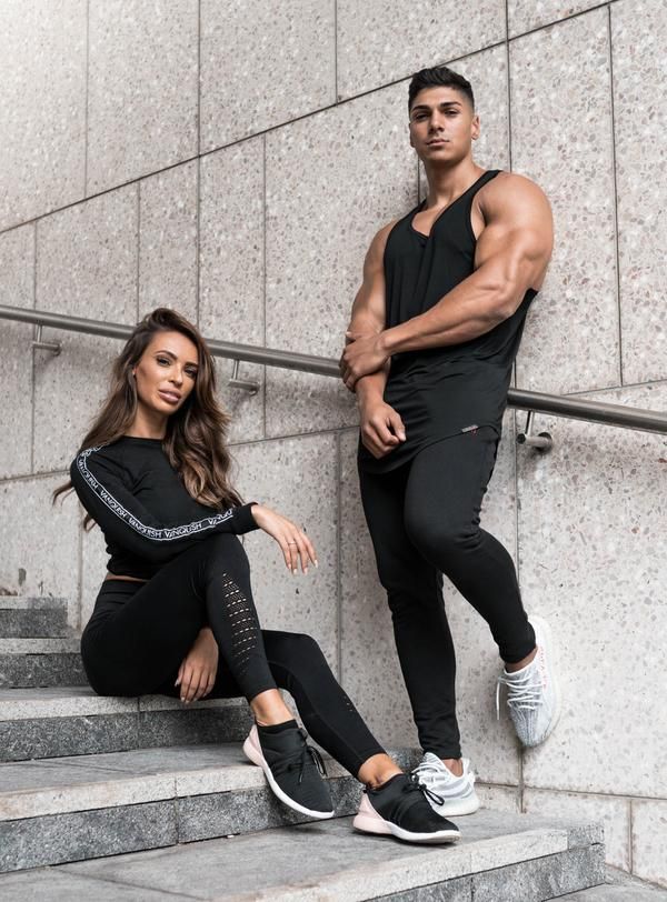 a man and woman sitting on some stairs