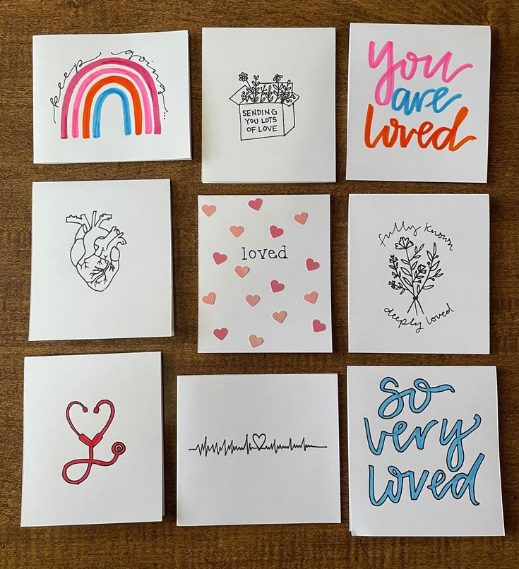 six handmade cards with different designs on them, all written in rainbow colors and the words you are loved