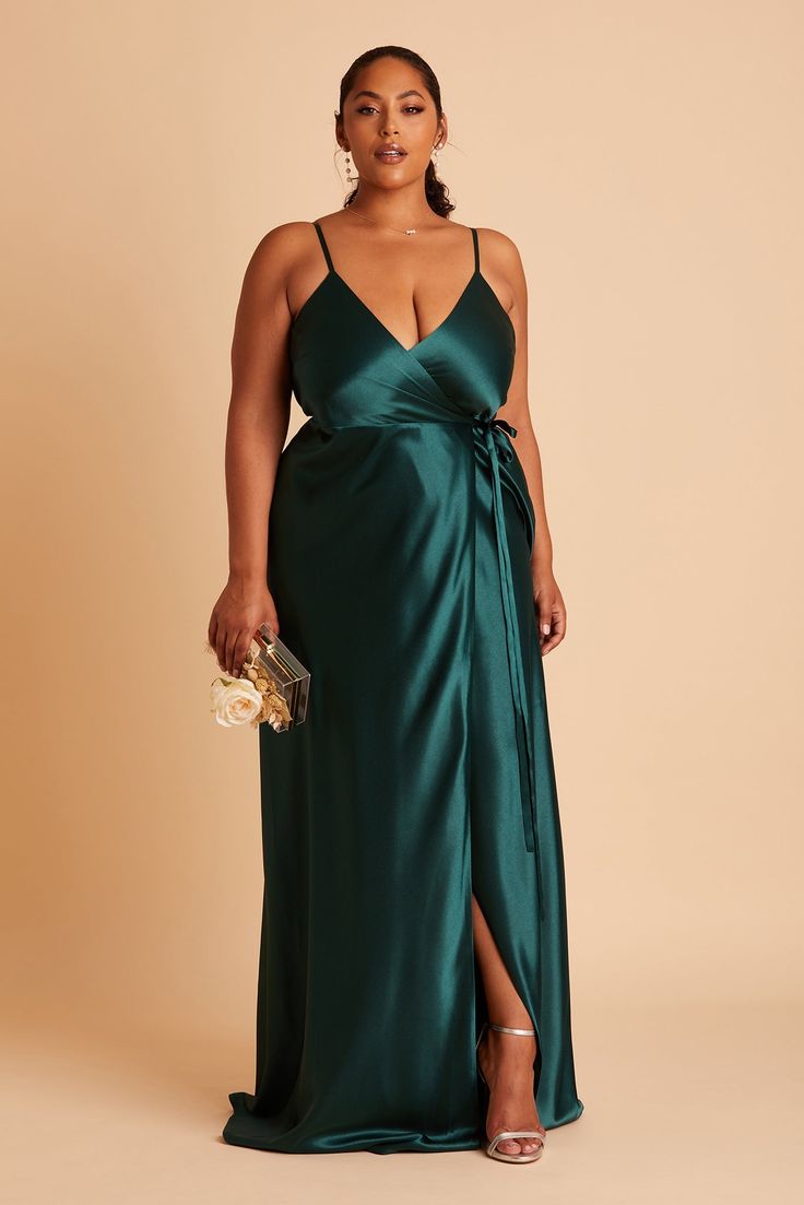 Your bridesmaids will shimmer in this satin wrap dress, with its plunging neckline and feminine side bow. This wrap dress delivers on the sexy, with its deep-V neckline and a high slit. For optimum fit, wear a backless bra and wrap the dress as tightly as possible around your bust (where your bra band sits). | Emerald Bridesmaid Dress Shiny Satin Size XS | Birdy Grey Cindy Plus Size Satin Dress, Emerald Bridesmaid Dress, Jewel Tone Bridesmaid, Emerald Bridesmaid, Emerald Green Bridesmaid Dresses, Cindy Dress, Bridesmaid Satin, Satin Gowns, Emerald Bridesmaid Dresses