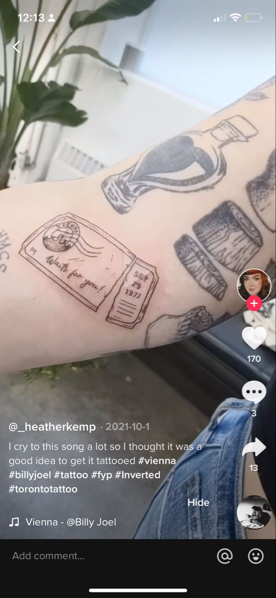 a person's arm with tattoos on it and an instagramr in the background