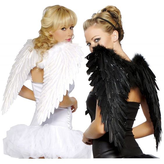 two women dressed up in costumes with wings on their shoulders, one wearing a white dress and the other black