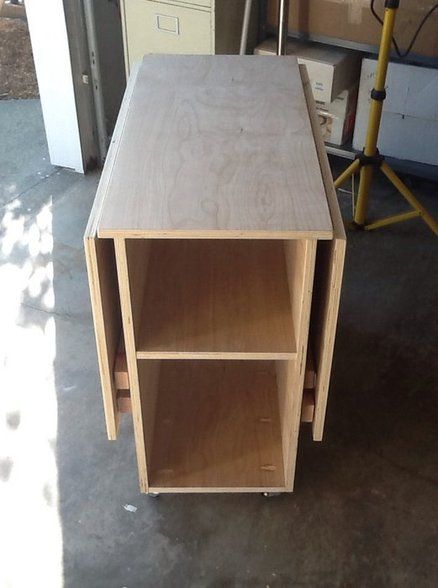 a wooden table sitting on top of a garage floor