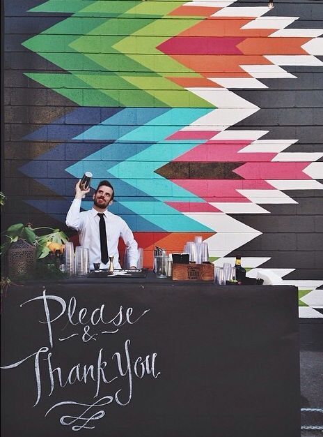 a man standing in front of a sign that says please and thank you