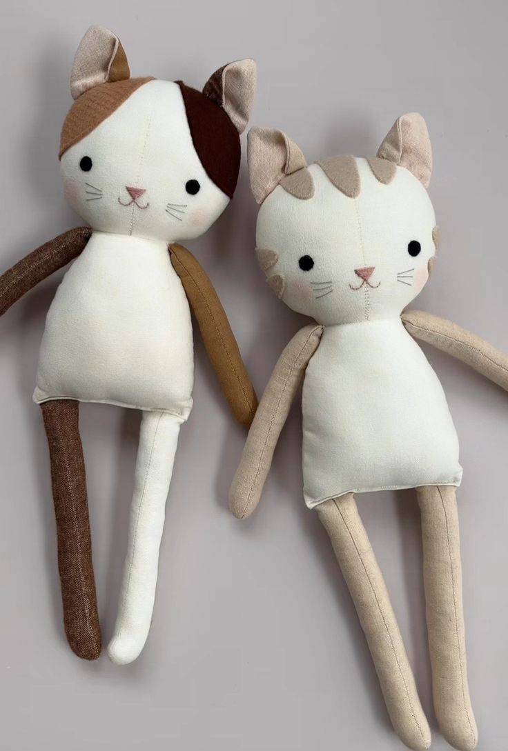 two stuffed cats sitting next to each other