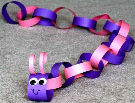 a purple and pink paper chain with eyes on it