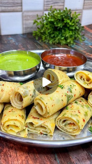 some food is sitting on a plate with dipping sauces and a green cup in the background