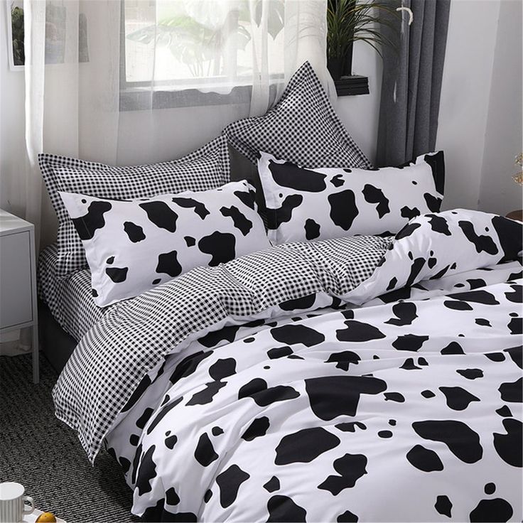 black and white cow print bedding in a bedroom