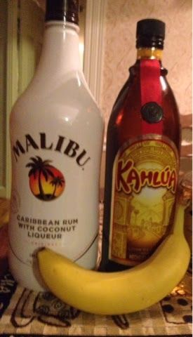 two bottles and a banana sitting on a counter