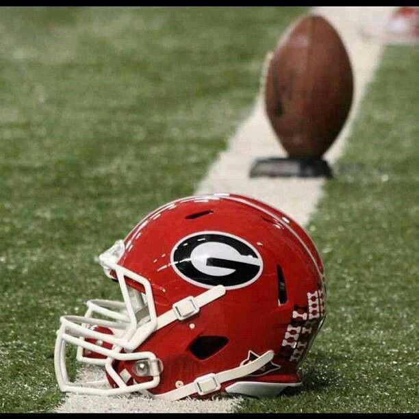 a football helmet sitting on the sidelines