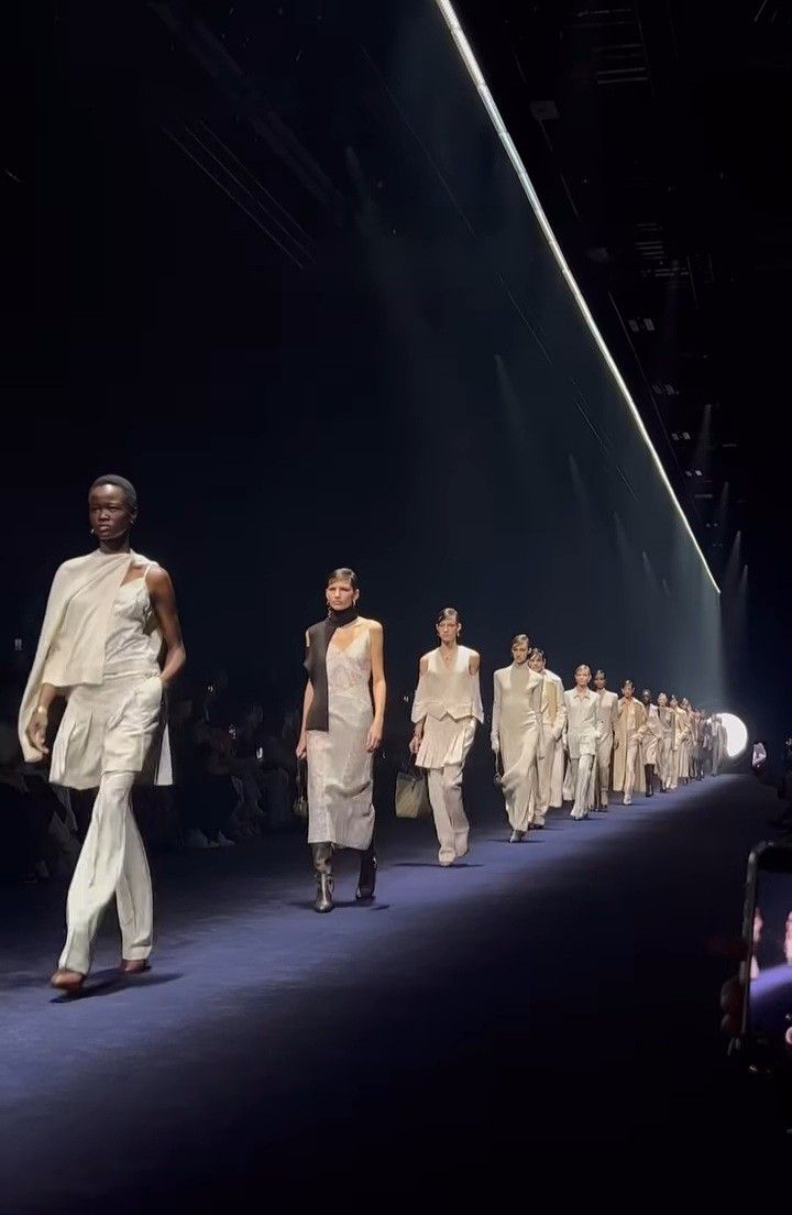 several models walking down the runway at a fashion show