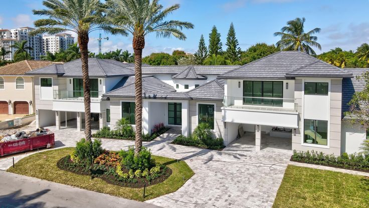 an aerial view of a house with palm trees