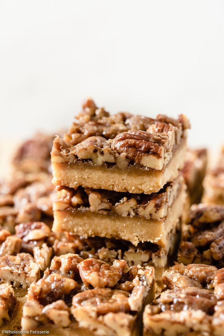 several pieces of pecan bars stacked on top of each other