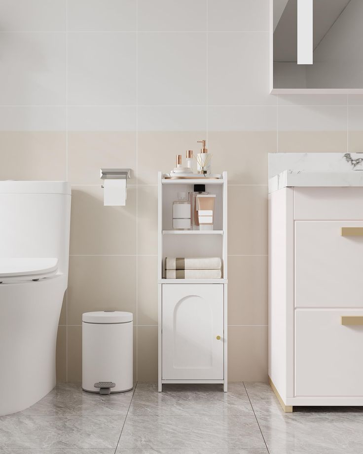 a white toilet sitting next to a bathroom sink