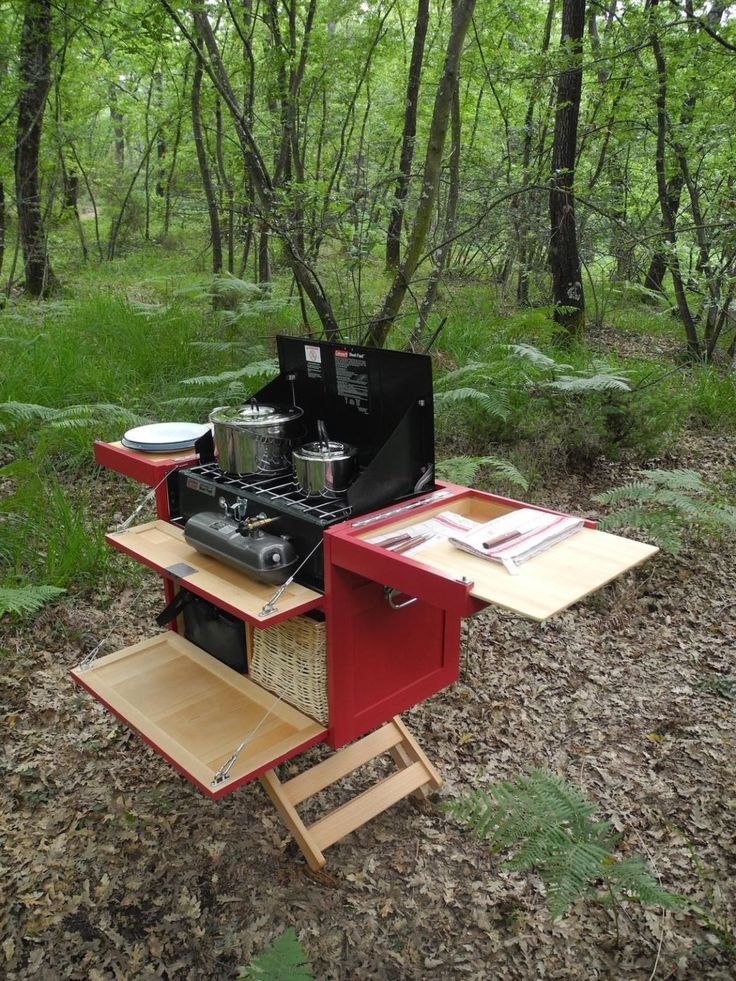 an outdoor stove is set up in the woods