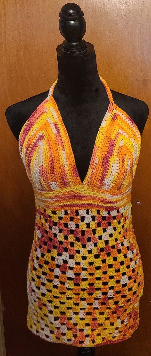 a mannequin wearing an orange and yellow halter top