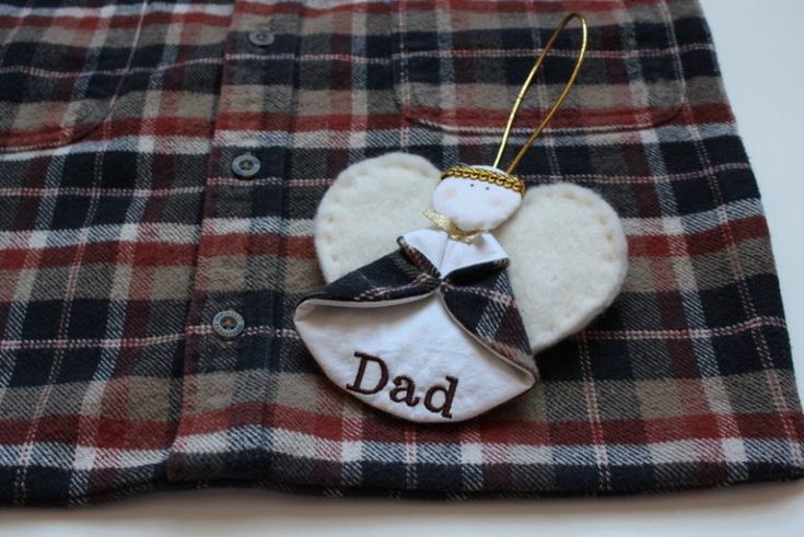 a close up of a button down shirt with an ornament hanging from it