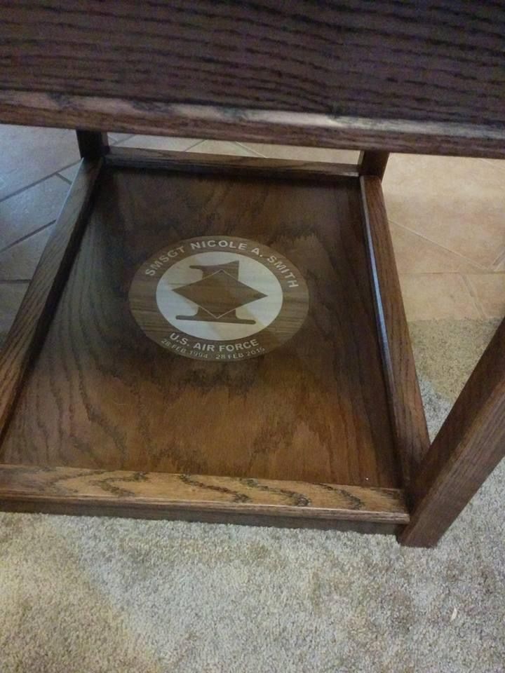 a close up of a wooden table with a sign on the top and bottom shelf